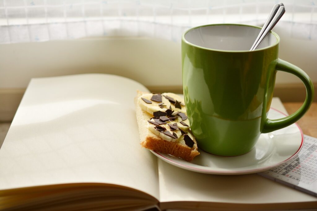 cup, a book, breakfast-2123710.jpg
